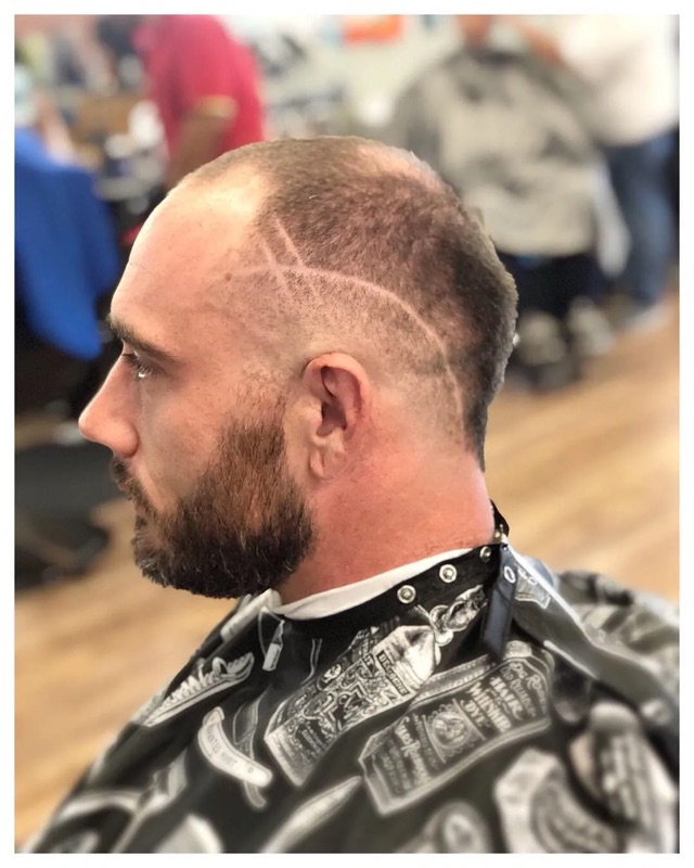 Skin fade with cross design and beard